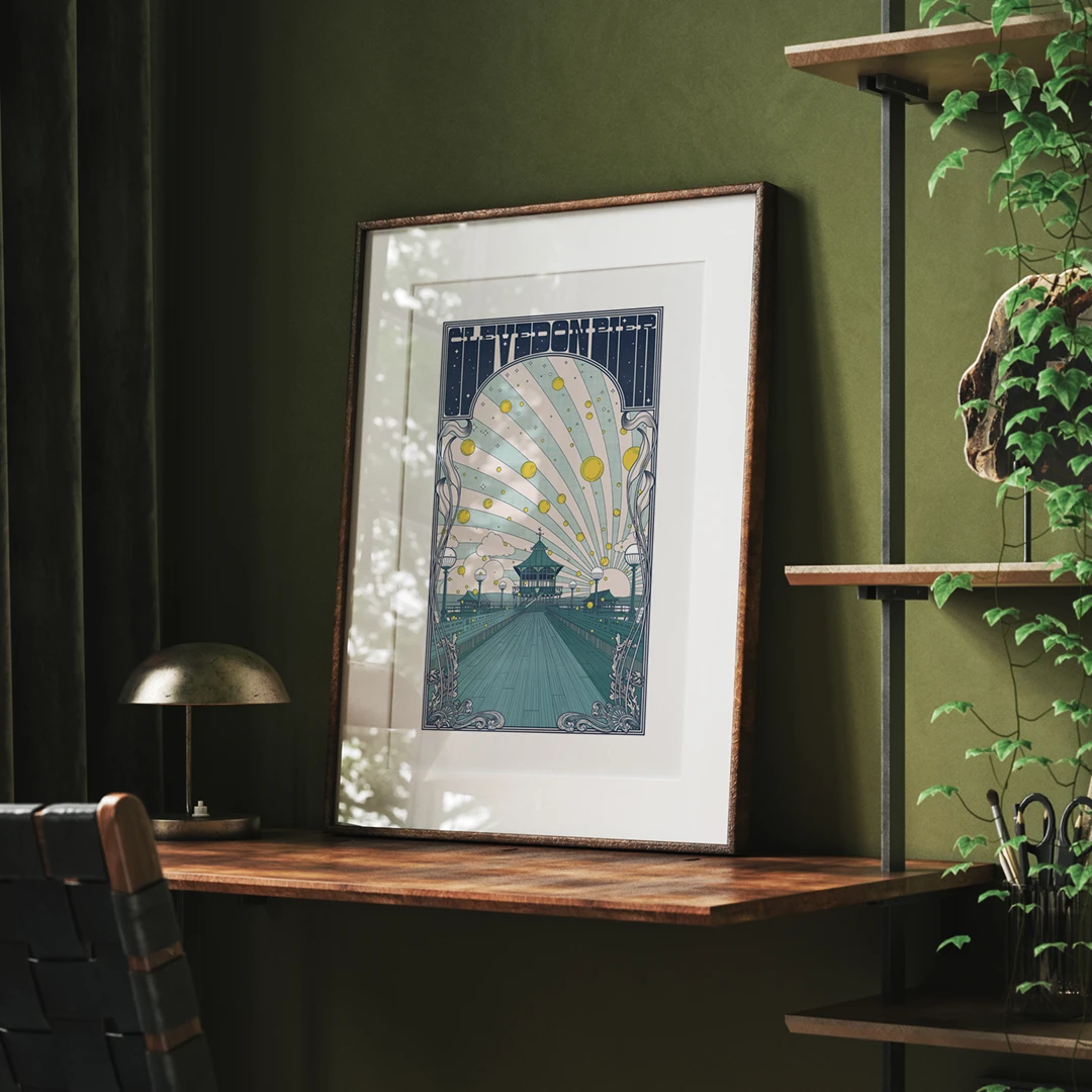 Print of Clevedon Pier on a desk in a green study with soft light and dappled lighting